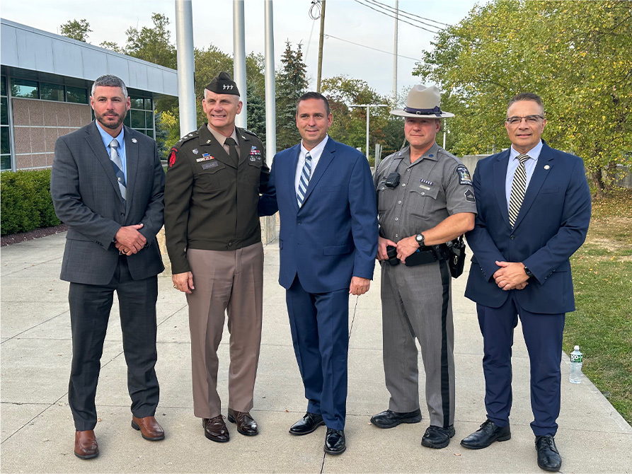 Steve Neuhaus with a law enforcement officer and member of the military